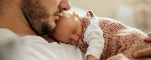 Napping infant sleeping on their napping father