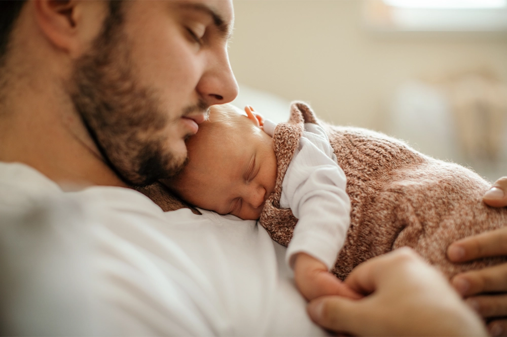 Napping infant sleeping on their napping father