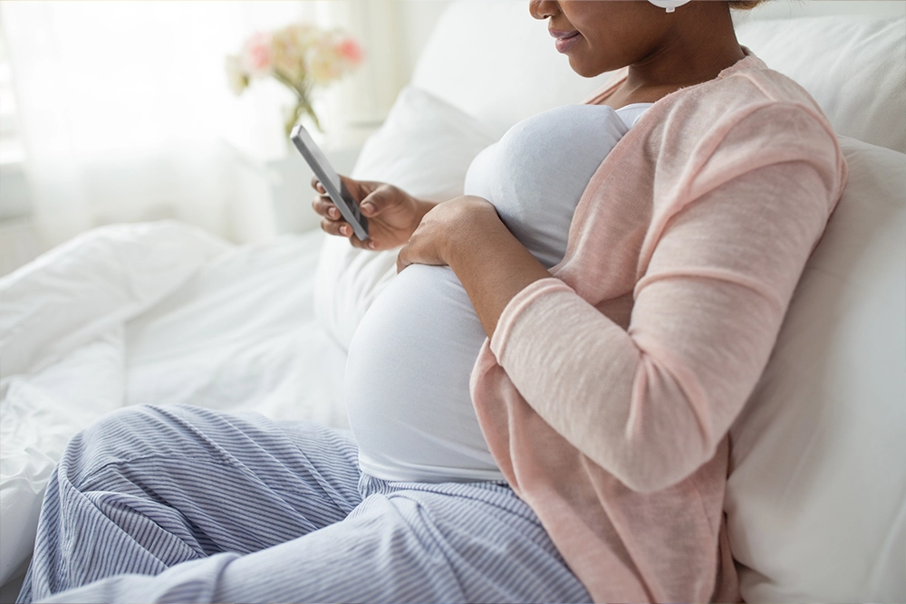 Pregnant woman on the phone with social worker